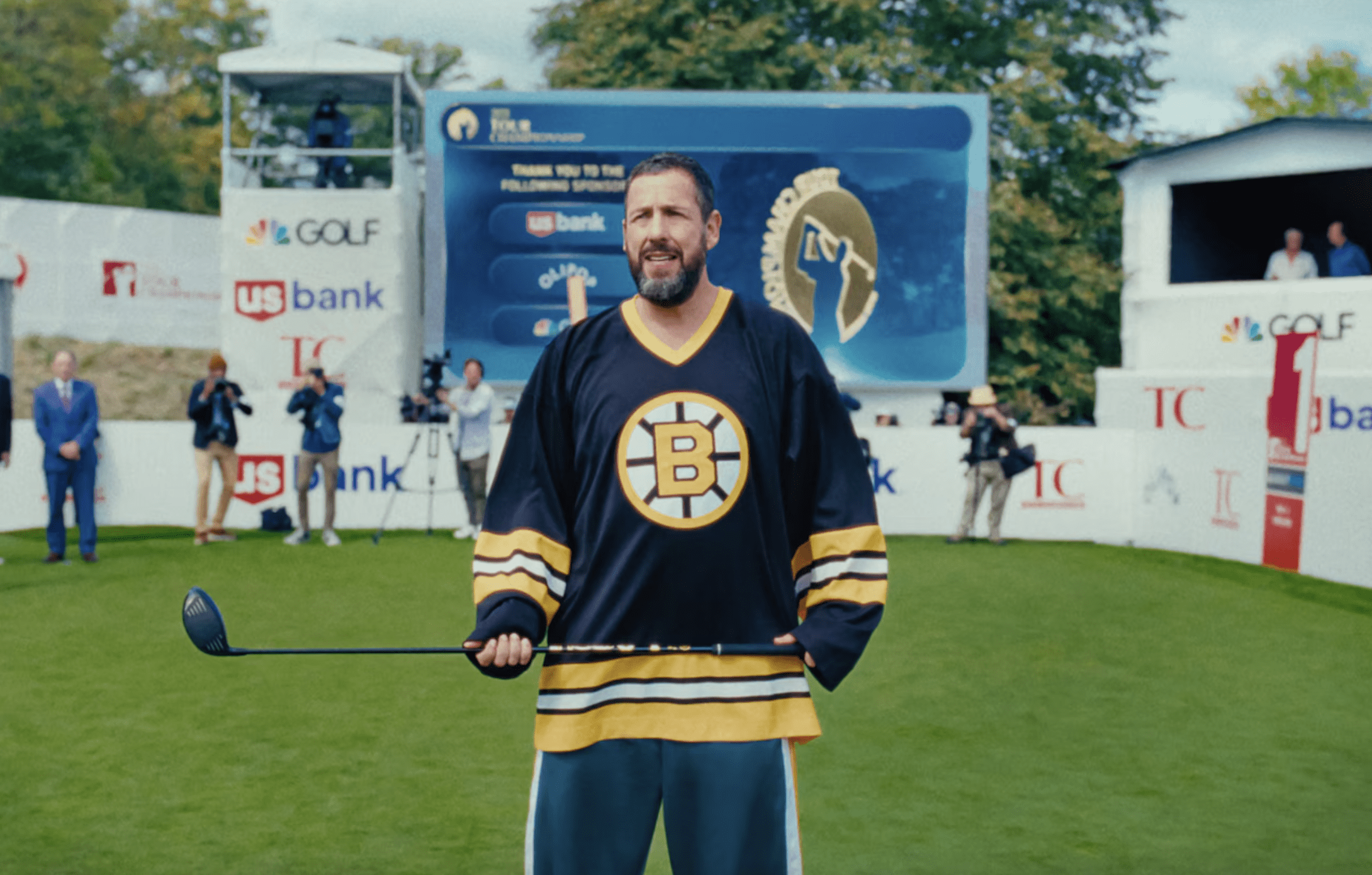 Adam Sandler as Happy Gilmore standing with golf club in hand